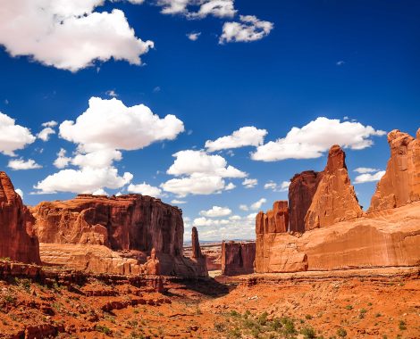 Arches National Park landscape view with blue sky and white clouds, Utah, USA